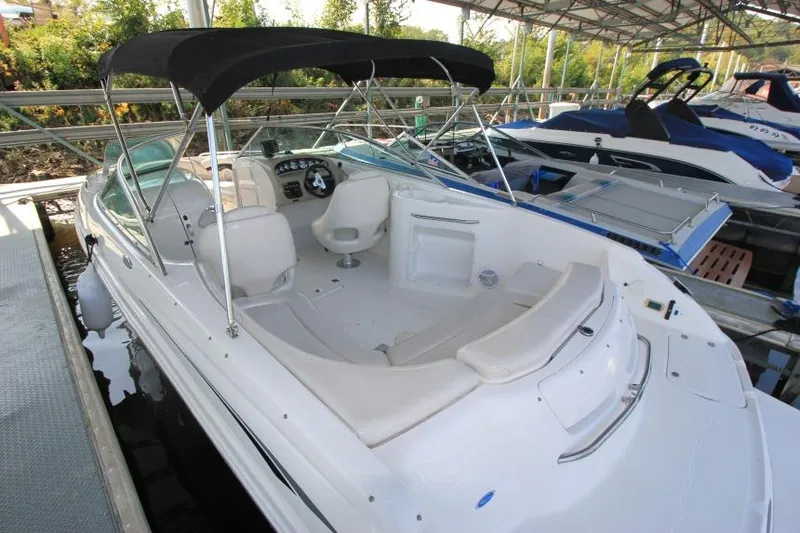 Slide: The Image of 2002 Chaparral 220 SSi boat with canopy, docked in a marina. - 4