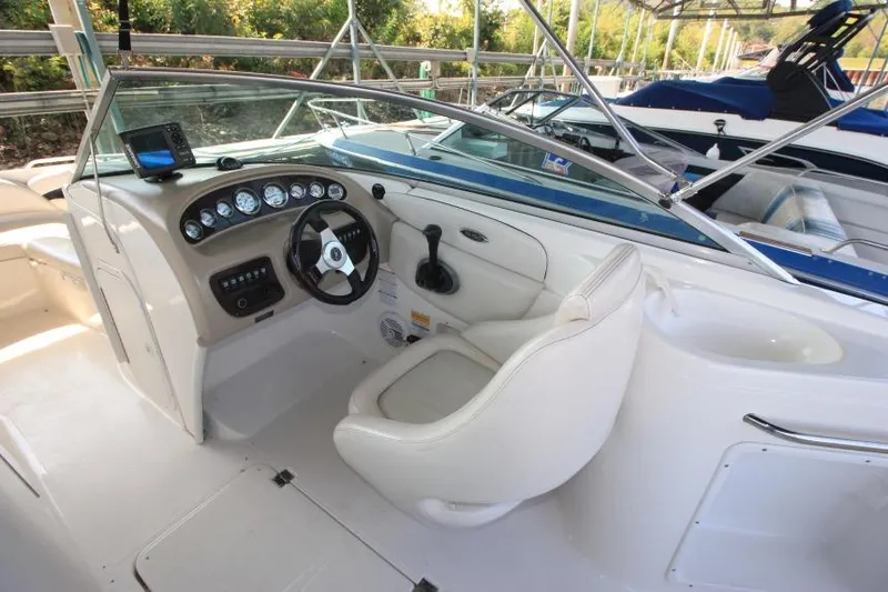 Slide: The Image of 2002 Chaparral 220 SSi boat interior with steering wheel and dashboard controls. - 9
