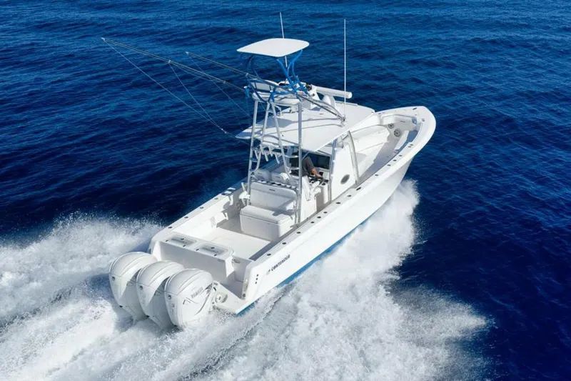 Slide: The Image of 2023 Contender 39 ST boat cruising on open blue ocean waters. - 13