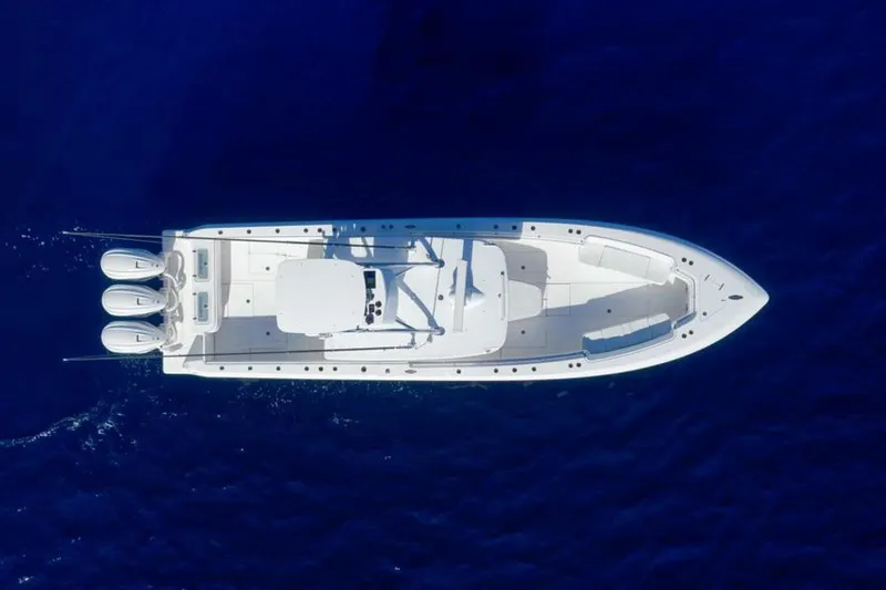 Slide: The Image of Aerial view of 2023 Contender 39 ST boat on deep blue water. - 14