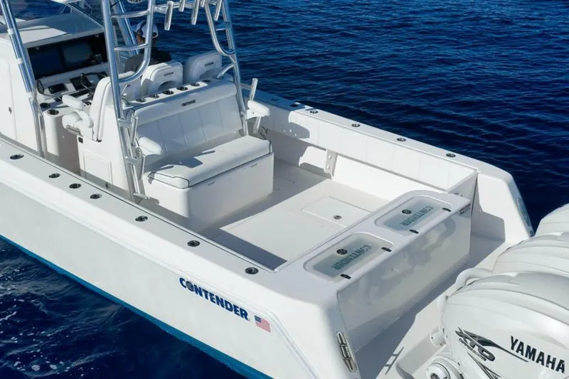 Slide: The Image of 2023 Contender 39 ST boat with Yamaha engines on open blue water. - 17