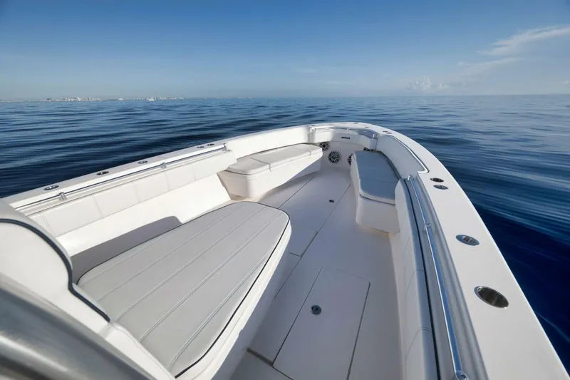 Slide: The Image of 2023 Contender 39 ST boat on calm ocean, showcasing spacious deck and seating. - 18