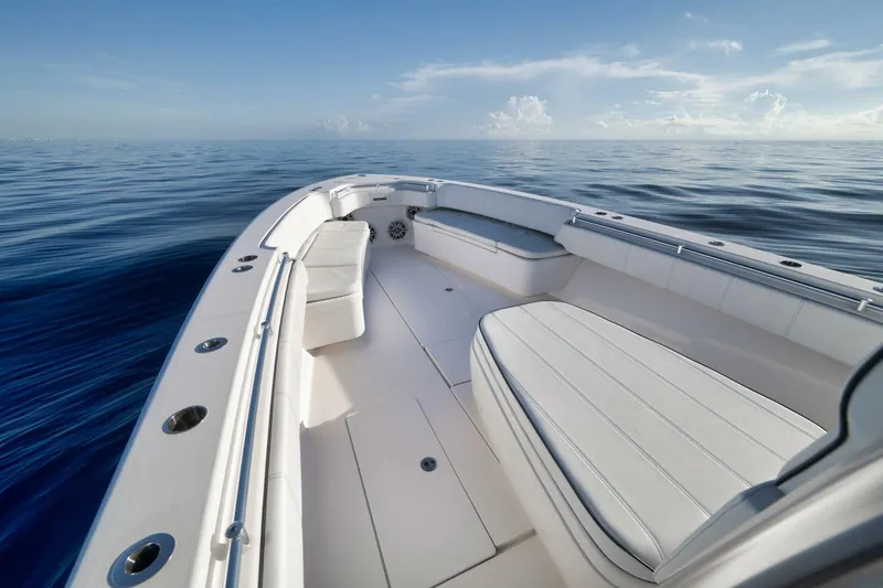 Slide: The Image of 2023 Contender 39 ST boat interior on calm ocean, showcasing spacious seating and sleek design. - 19
