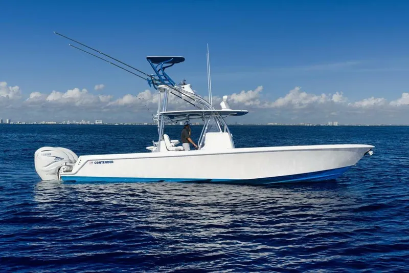 Slide: The Image of 2023 Contender 39 ST boat on open ocean under clear blue sky. - 2