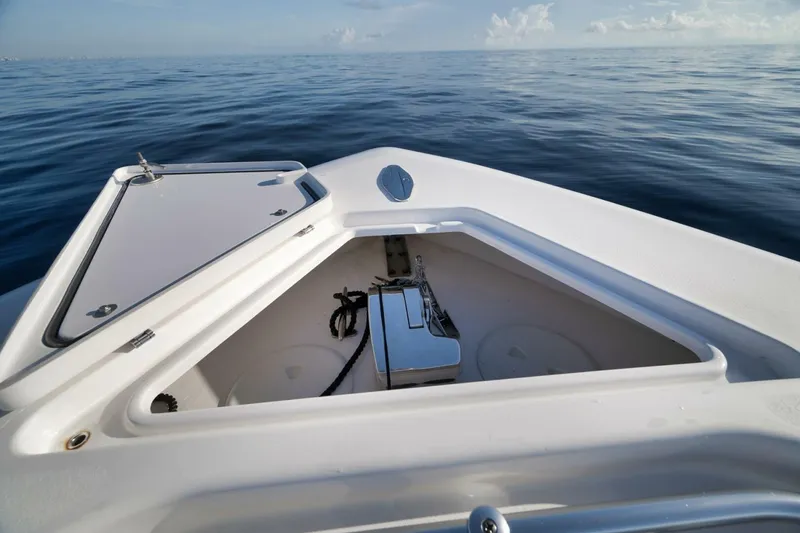 Slide: The Image of 2023 Contender 39 ST boat anchor compartment on calm ocean waters. - 21