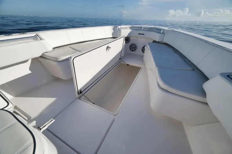 Slide: The Image of 2023 Contender 39 ST boat interior with white seating and storage compartments. - 25