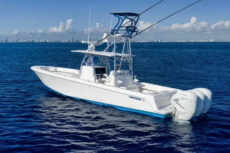 Slide: The Image of 2023 Contender 39 ST boat on open ocean with city skyline in background. - 3