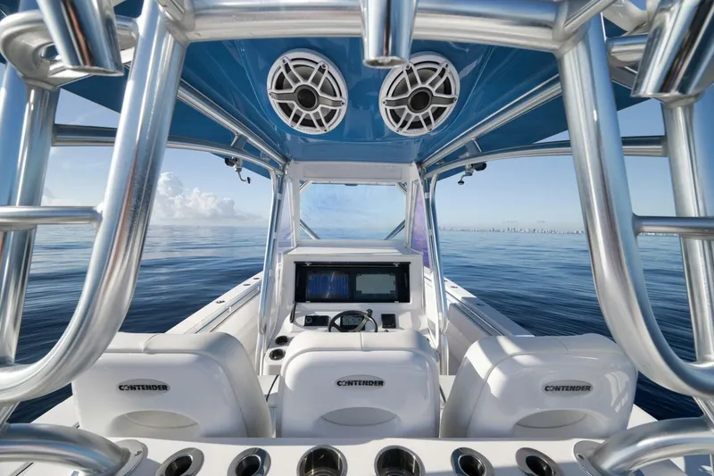 Slide: The Image of 2023 Contender 39 ST boat interior with advanced navigation system and ocean view. - 34