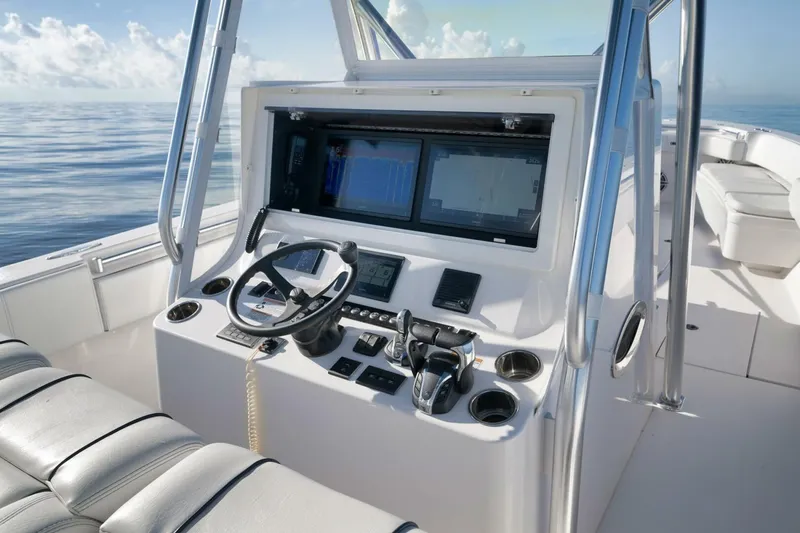 Slide: The Image of 2023 Contender 39 ST boat cockpit with modern controls and navigation screens. - 36