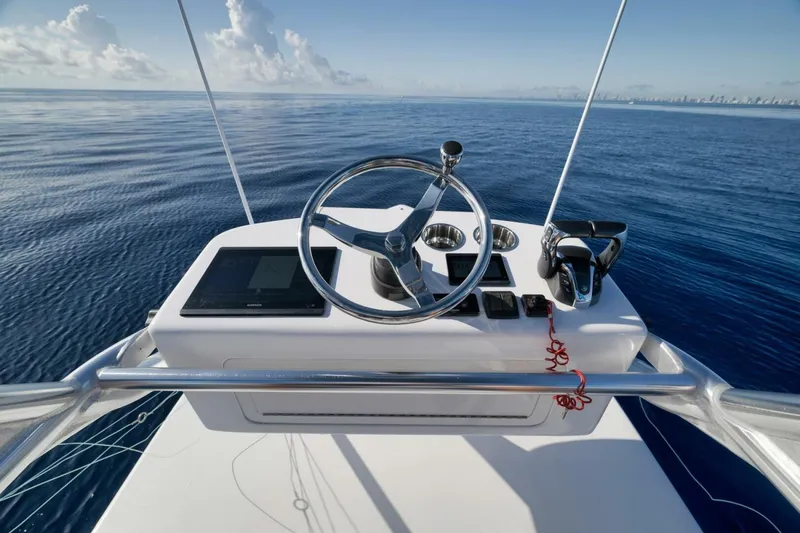 Slide: The Image of Helm of 2023 Contender 39 ST boat with ocean view and clear sky. - 39