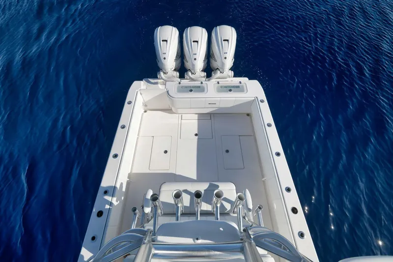 Slide: The Image of 2023 Contender 39 ST boat with triple engines on clear blue water. - 40