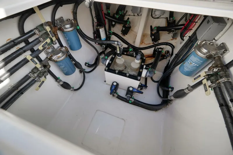 Slide: The Image of Engine compartment of 2023 Contender 39 ST boat, showcasing fuel filters and hoses. - 43