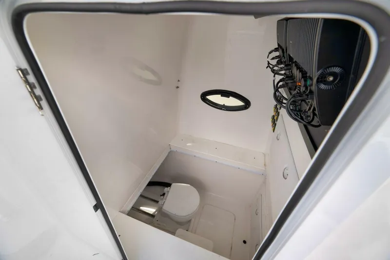 Slide: The Image of 2023 Contender 39 ST boat interior with compact bathroom and equipment panel. - 44