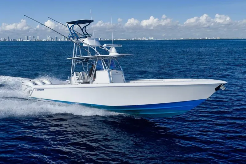 Slide: The Image of 2023 Contender 39 ST boat cruising on open ocean with city skyline in background. - 6