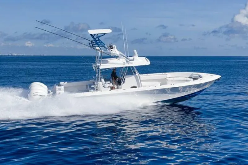 Slide: The Image of 2023 Contender 39 ST boat cruising on open ocean under clear blue sky. - 7
