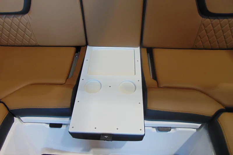 Slide: The Image of 2026 Yamaha Boats 252SD interior seating with cup holders and tan upholstery. - 10