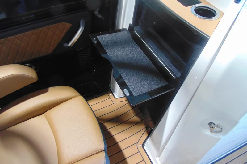 Slide: The Image of 2026 Yamaha Boats 252SD interior with tan seating and fold-out table. - 15