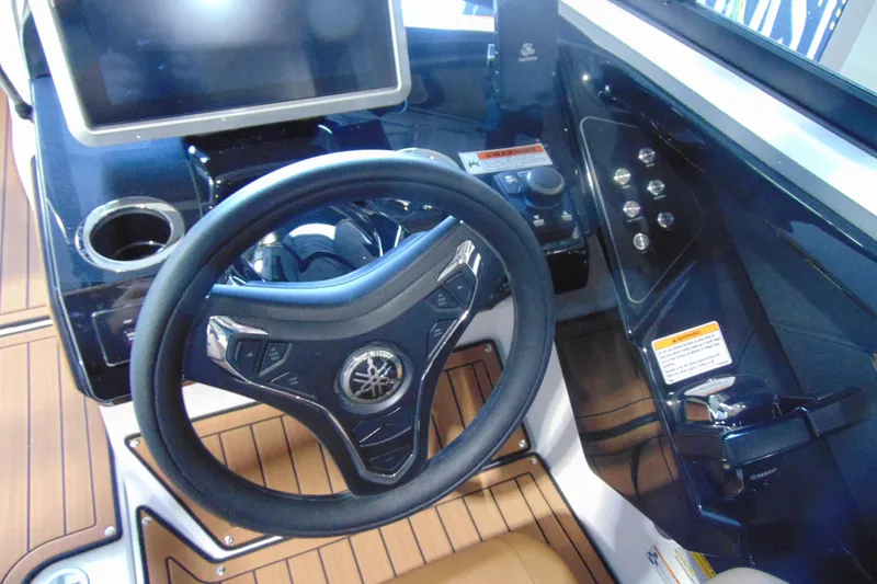 Slide: The Image of 2026 Yamaha Boats 252SD helm with steering wheel, touchscreen, and control panel. - 18