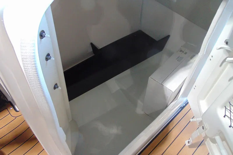 Slide: The Image of Storage compartment of 2026 Yamaha Boats 252SD, featuring sleek interior design and ample space. - 19