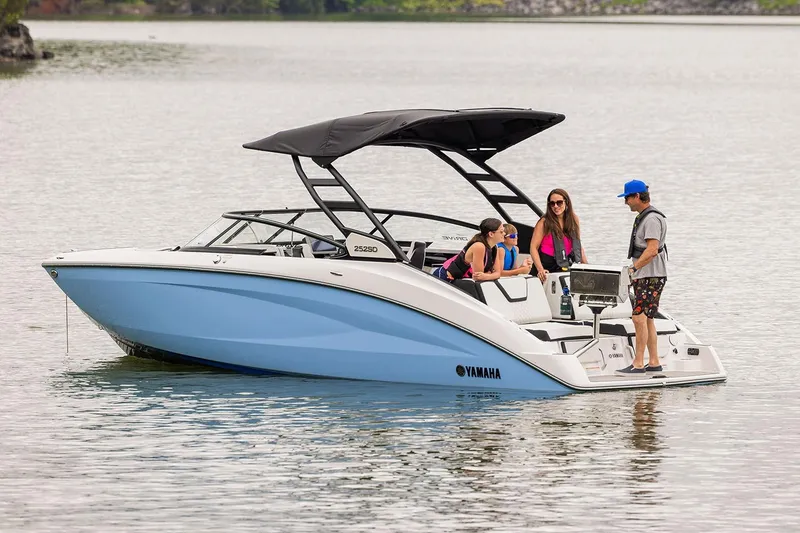 Slide: The Image of 2026 Yamaha Boats 252SD on trailer in showroom, sleek black and white design. - 3