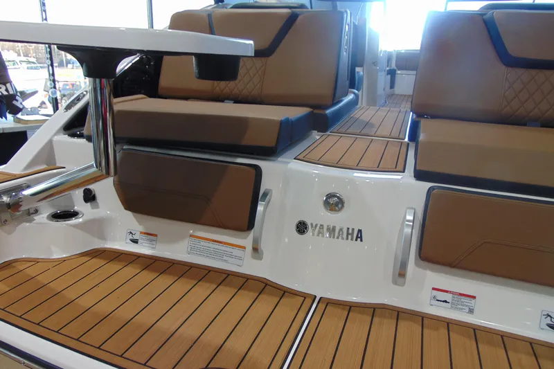 Slide: The Image of 2026 Yamaha Boats 252SD interior with teak flooring and cushioned seating. - 6