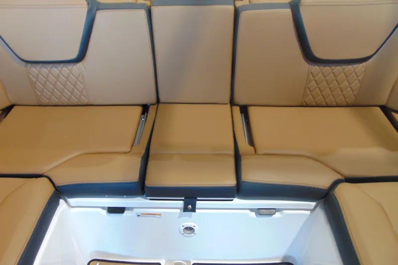 Slide: The Image of Luxurious tan seating on 2026 Yamaha Boats 252SD, featuring diamond stitching and storage compartment. - 9