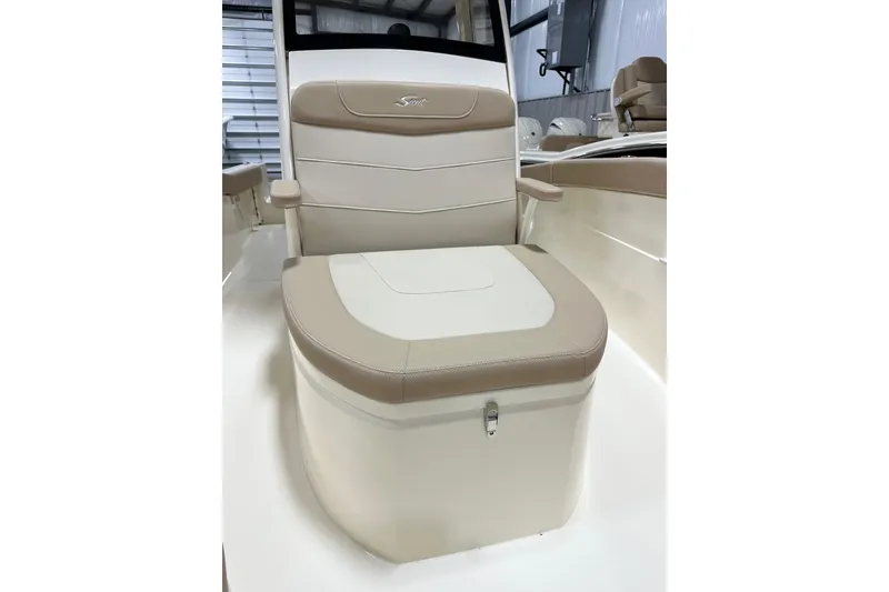Slide: The Image of 2026 Scout 240 XSF boat seat with beige and white upholstery in a showroom. - 11