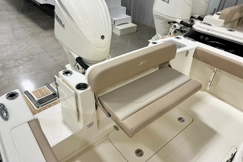 Slide: The Image of 2026 Scout 240 XSF boat interior with Yamaha engine and beige seating. - 13