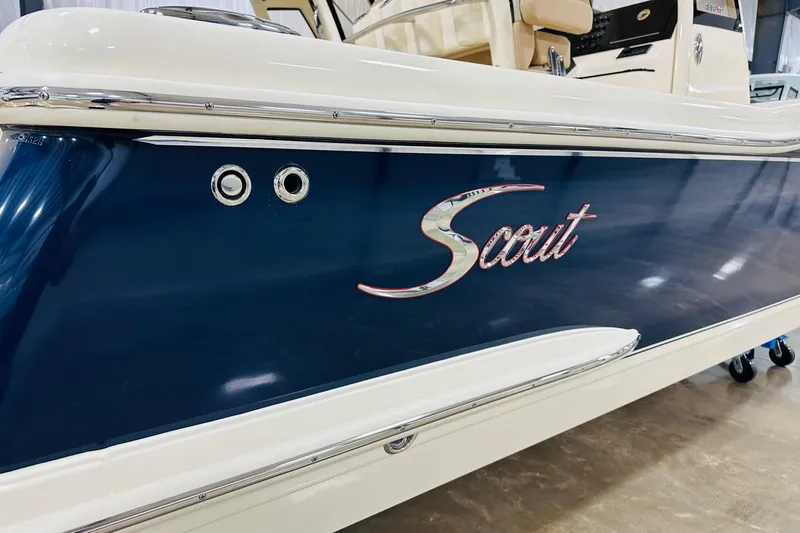Slide: The Image of 2026 Scout 240 XSF boat with sleek blue and white design. - 16