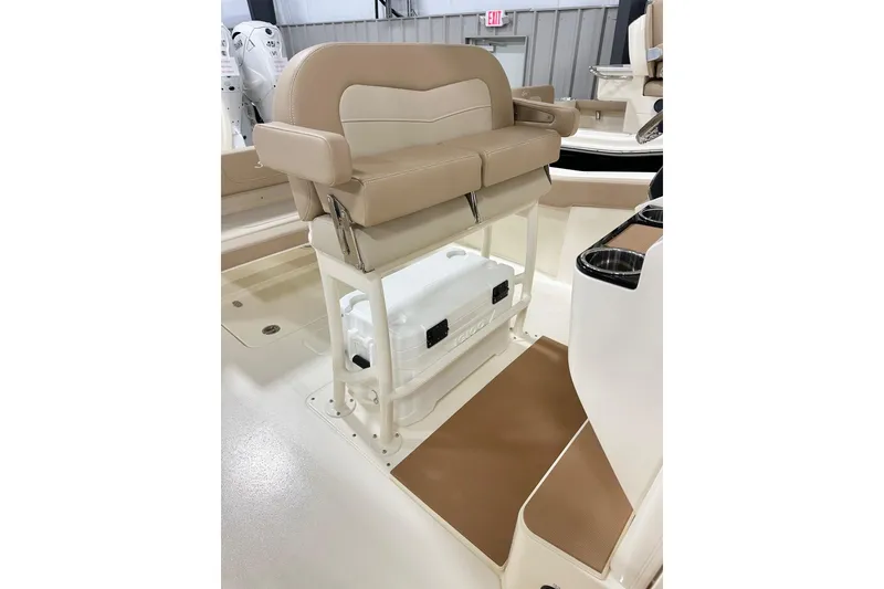 Slide: The Image of 2026 Scout 240 XSF boat interior with tan seating and storage area. - 5