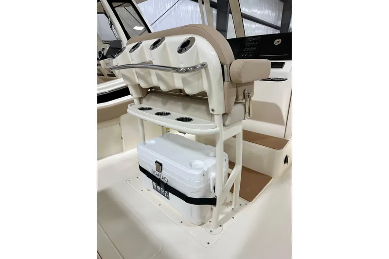 Slide: The Image of 2026 Scout 240 XSF boat interior with seating and cooler storage. - 6