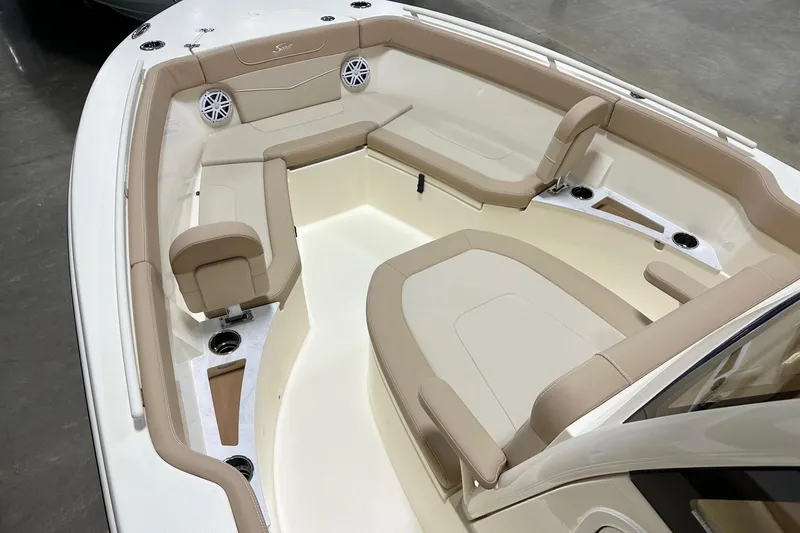Slide: The Image of 2026 Scout 240 XSF boat interior with beige seating and cup holders. - 8