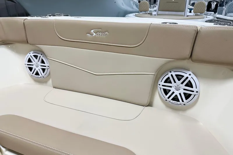 Slide: The Image of 2026 Scout 240 XSF boat interior with beige seating and JL Audio speakers. - 9