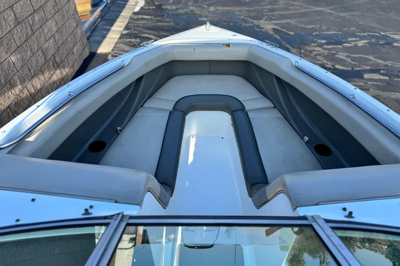 Slide: The Image of Interior view of a 1996 Cobalt 232 boat, featuring cushioned seating and cup holders. - 10