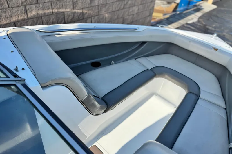 Slide: The Image of Interior seating of a 1996 Cobalt 232 boat, featuring gray and white upholstery. - 11