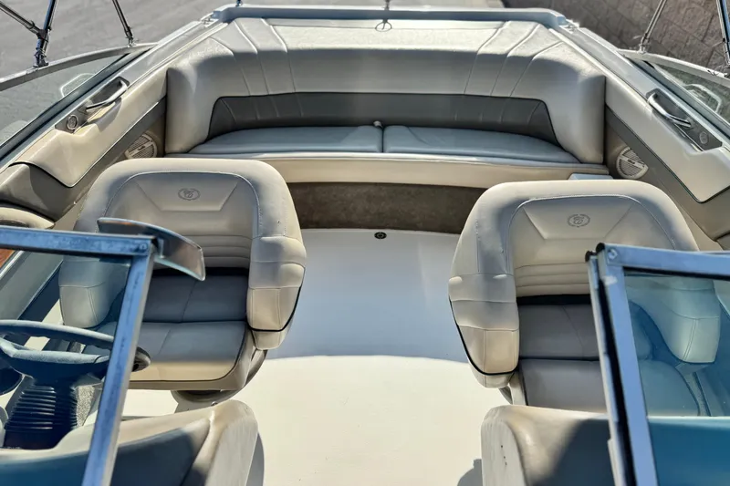 Slide: The Image of Interior of a 1996 Cobalt 232 boat with plush seating and steering wheel. - 13