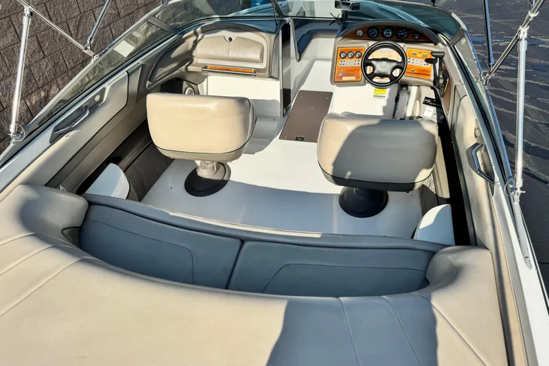 Slide: The Image of Interior of a 1996 Cobalt 232 boat with beige seating and wooden dashboard. - 17