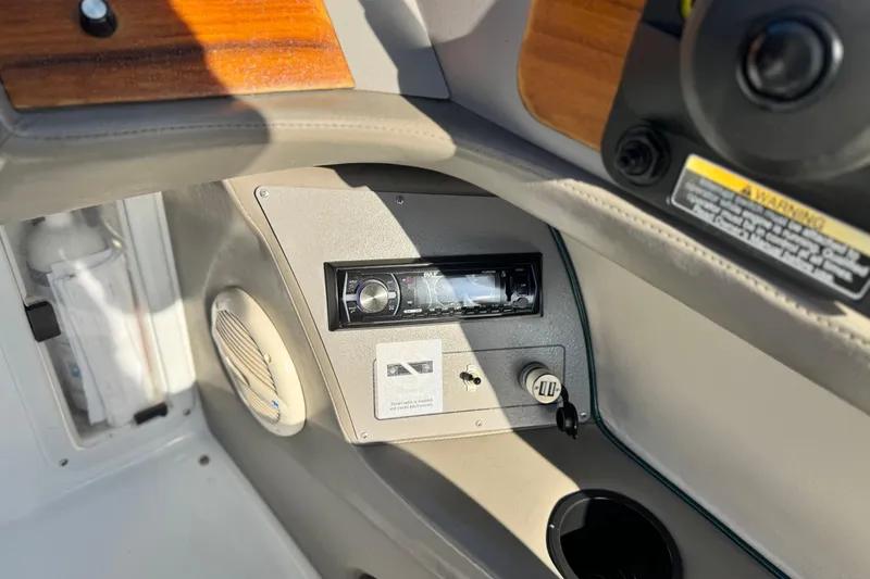 Slide: The Image of 1996 Cobalt 232 boat dashboard with stereo system and speaker. - 23