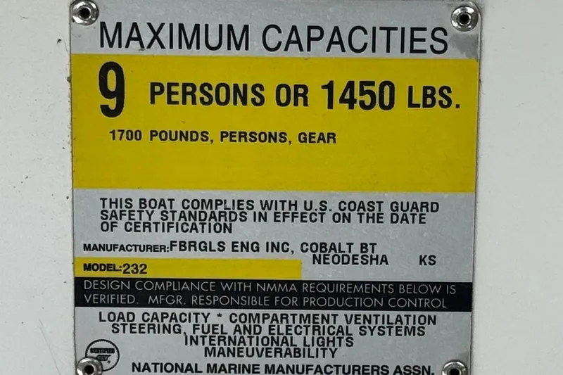 Slide: The Image of 1996 Cobalt 232 boat capacity plate: 9 persons or 1450 lbs, USCG compliant. - 24