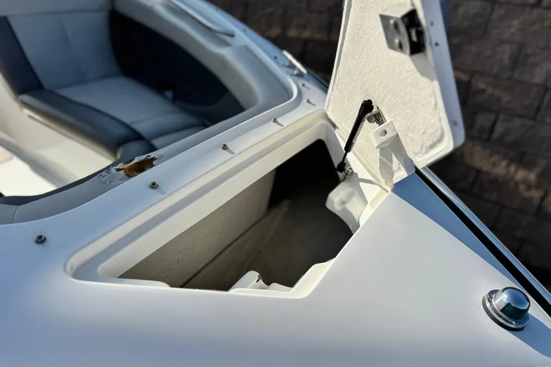 Slide: The Image of Open storage compartment on a 1996 Cobalt 232 boat, showing interior details. - 9