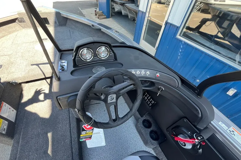 Slide: The Image of 2026 Crestliner 1750 Super Hawk boat dashboard with steering wheel and gauges. - 15