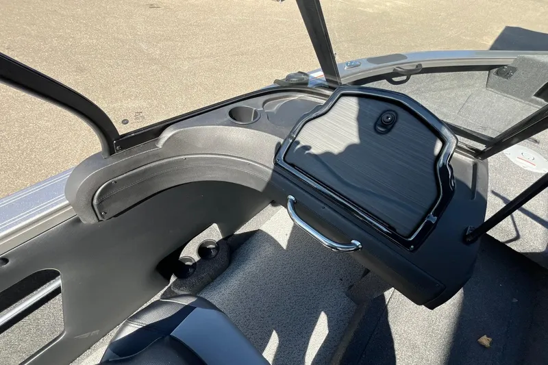 Slide: The Image of 2026 Crestliner 1750 Super Hawk interior dashboard with storage compartment and cup holders. - 16