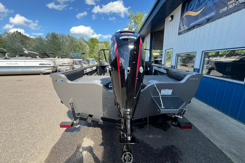 Slide: The Image of 2026 Crestliner 1750 Super Hawk boat with powerful outboard motor, parked outdoors. - 2