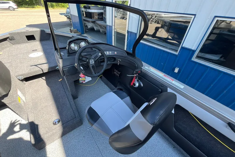 Slide: The Image of 2026 Crestliner 1750 Super Hawk boat interior with steering wheel and seating. - 8