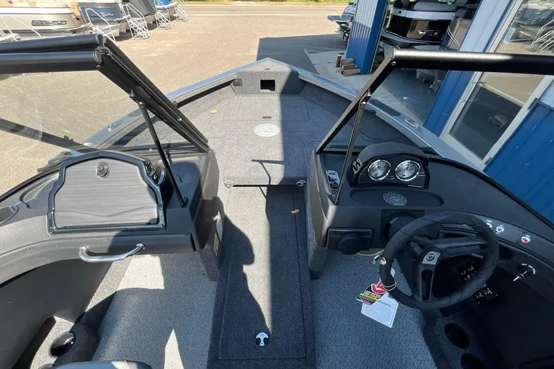 Slide: The Image of 2026 Crestliner 1750 Super Hawk boat interior with steering wheel and dashboard. - 9