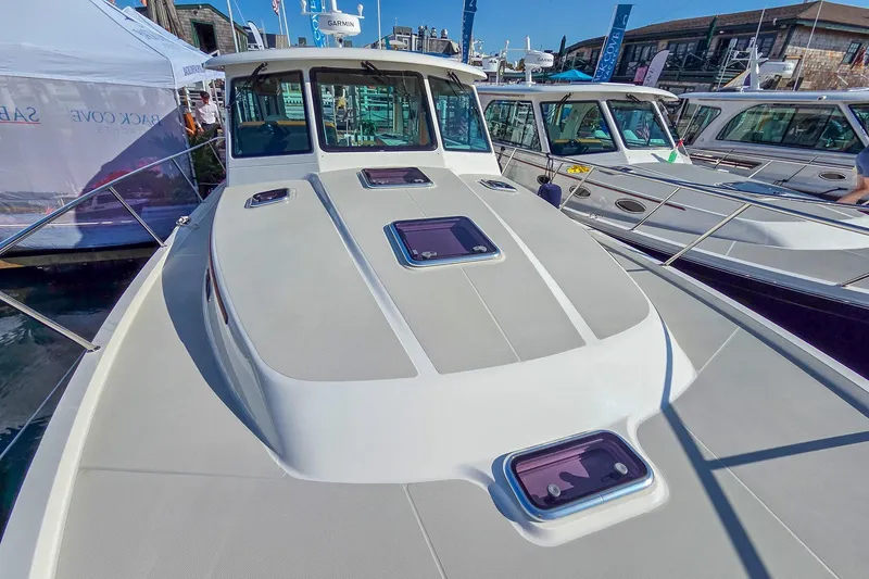 Slide: The Image of 2026 Back Cove 412 yacht on display at a boat show, showcasing sleek design and modern features. - 13