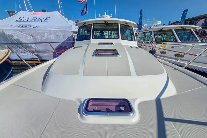Slide: The Image of 2026 Back Cove 412 yacht at a boat show, showcasing sleek design and modern features. - 14