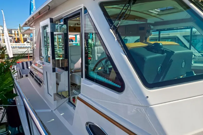 Slide: The Image of 2026 Back Cove 412 yacht exterior with open door and visible interior details. - 16