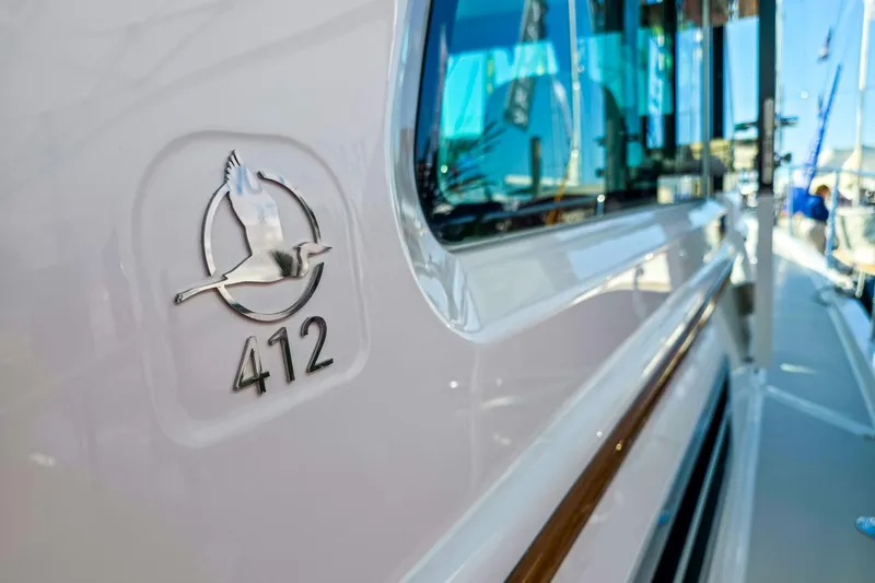 Slide: The Image of 2026 Back Cove 412 yacht emblem with sleek design and reflective surface. - 18