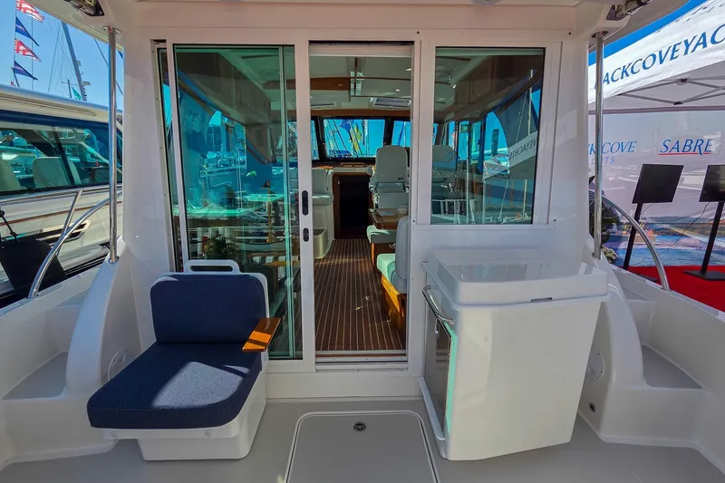 Slide: The Image of 2026 Back Cove 412 yacht interior with seating and glass doors. - 19